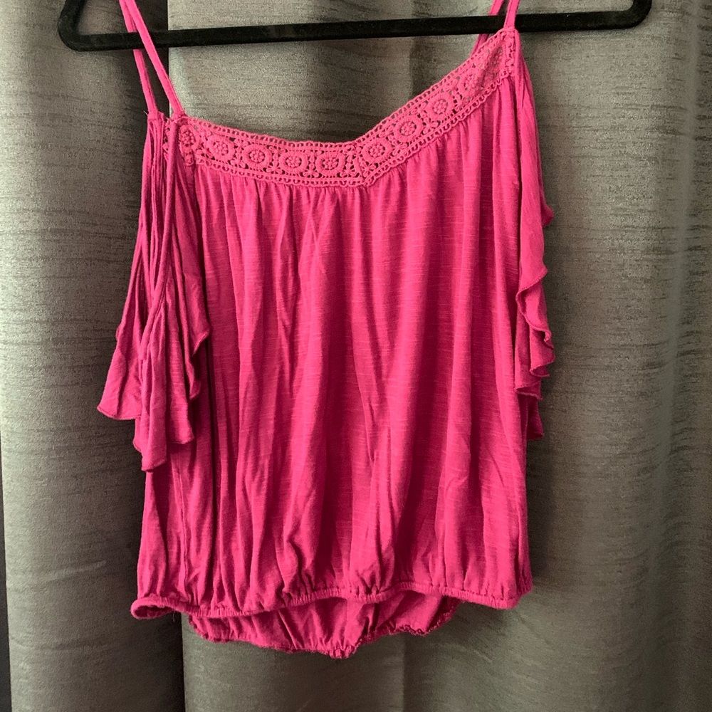 Pink tank top with cut out sleeves. Detail on top